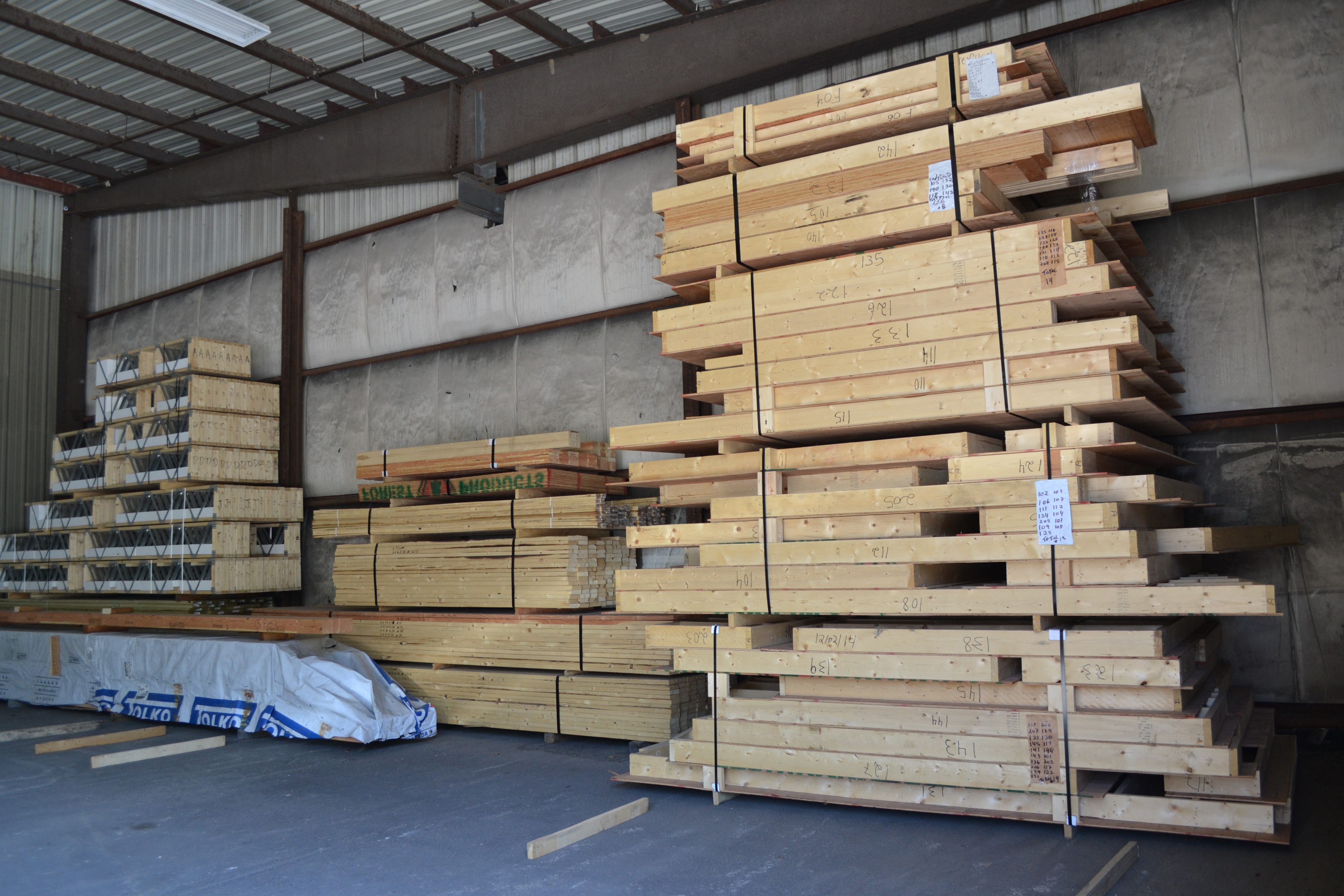Wall panels and floor trusses stacked and ready for shipment.
